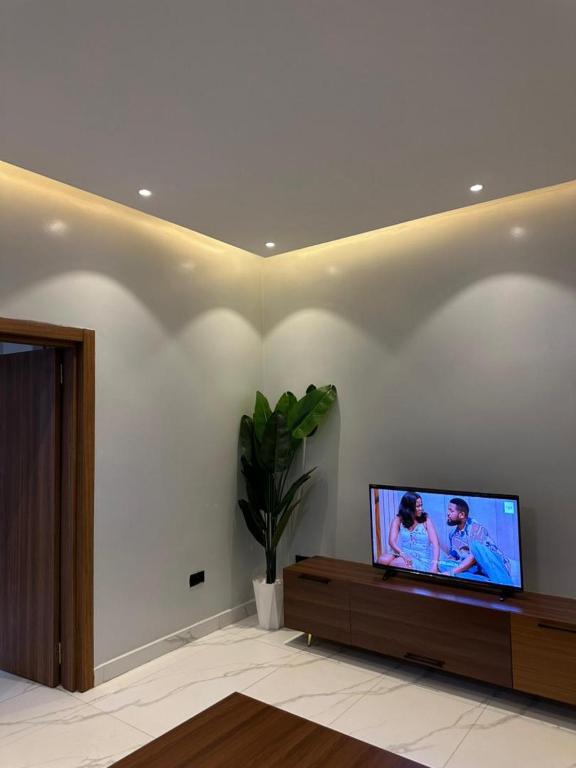 a living room with a flat screen tv on a wall at Bright 1BR Apartment Close to Everything in Kigali