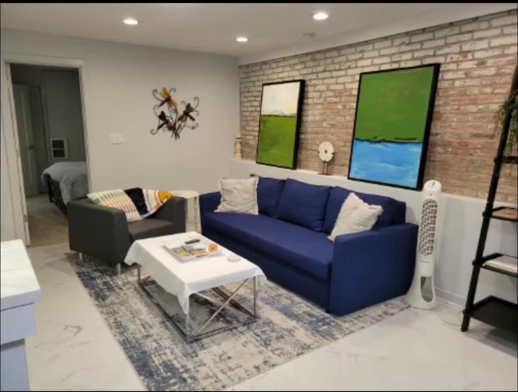 a living room with a blue couch and a table at Downtown and Inner Harbor Apartment in Baltimore