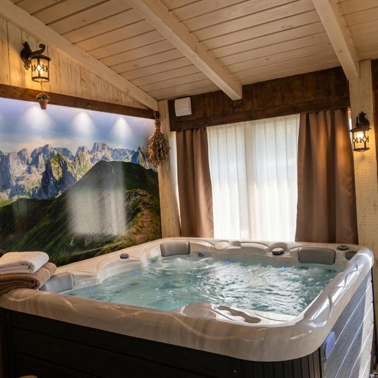 a large hot tub in a room with a painting at Vila Merak in Gusinje