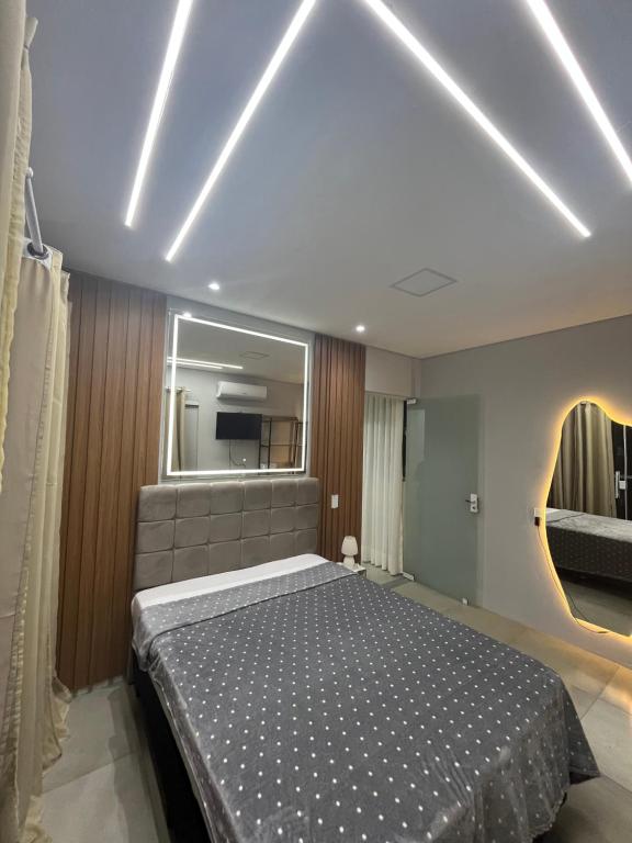 a bedroom with a bed and a large mirror at Recanto do Sol in Governador Celso Ramos