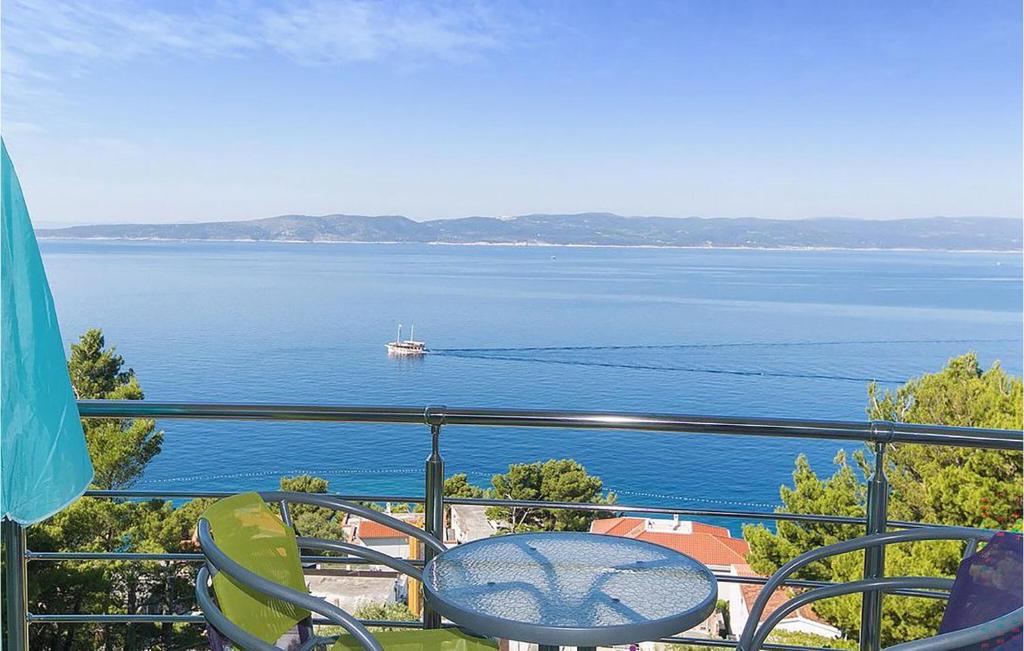 a balcony with a view of a boat in the water at Beautiful Apartment In Brela With Wifi in Brela
