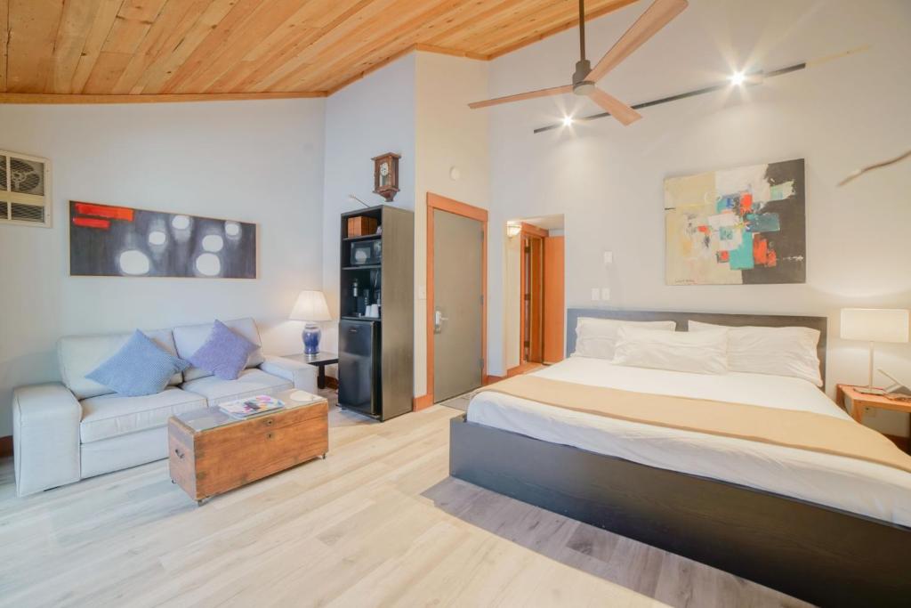 a bedroom with a large bed and a couch at Lodge Room 006 in Black Butte Ranch