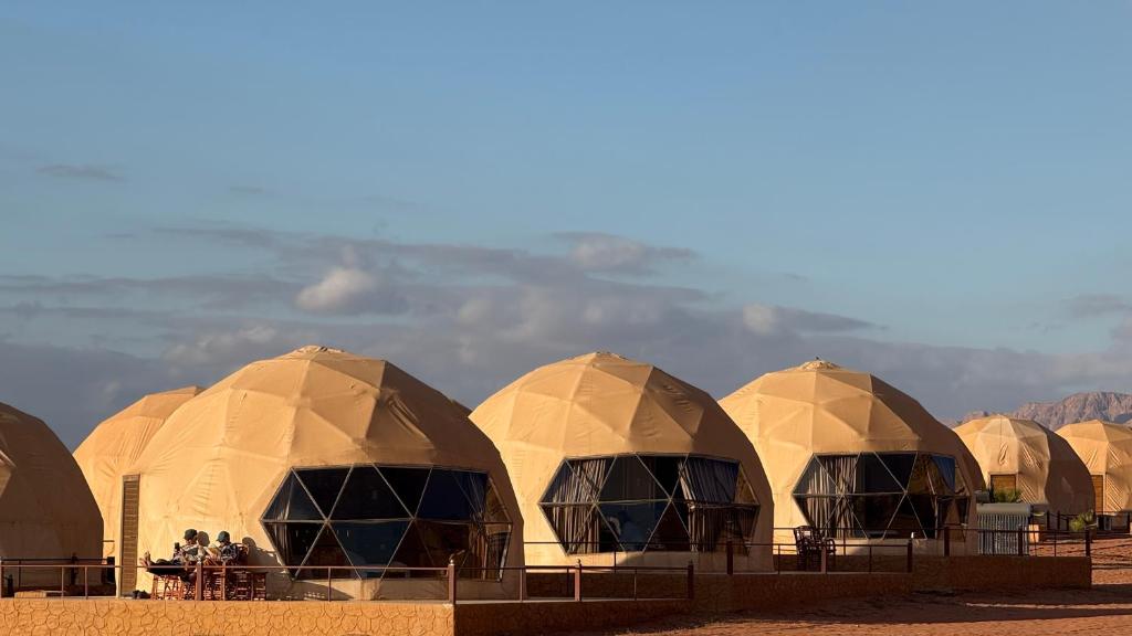 a row of domed tents in the desert at RUM PRESTIGE lUXURY CAMP & DESERT TOURS in Wadi Rum
