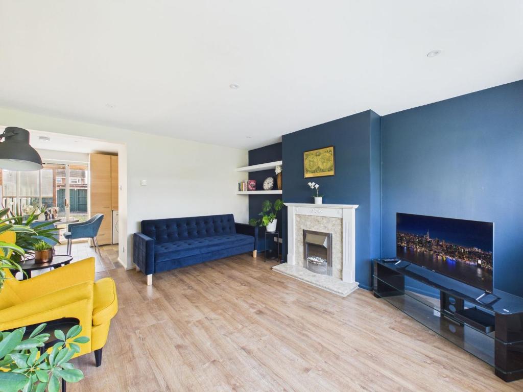 a living room with a couch and a fireplace at The Costwold Haven in Shurdington