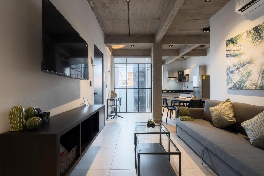 a living room with a couch and a table at Zielo Rentals Palma ,Private balcony, Rooftop Walk to Zocalo in Mexico City