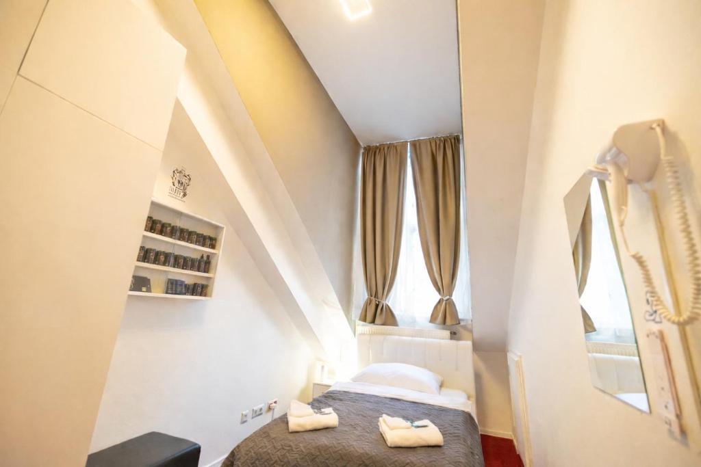 a small room with two beds in a attic at DATRI Petite Suite 4 in Vienna