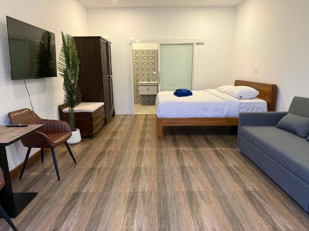 a hospital room with a bed and a couch at Roomz at Rawai in Ban Saiyuan (1)