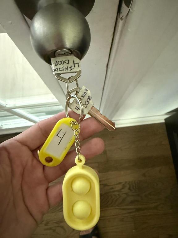 a hand holding a pair of keys and a key chain at Crema queen in Decatur