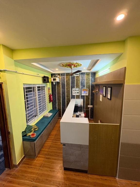 a kitchen with yellow walls and a counter in a room at Shanmikha Residency - Attur - Near Highways in Āttūr