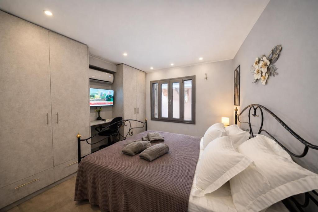 a bedroom with a bed with two pillows on it at Oniro Living - Skra 10 in Mytilene