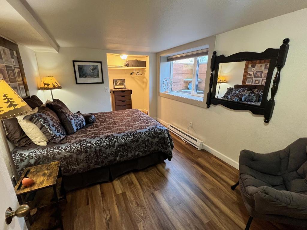 a bedroom with a bed and a couch and a window at Alaska Tucked Inn in Fairbanks