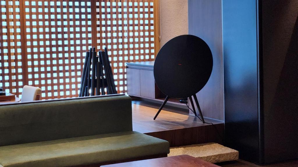 a room with a staircase and a chair next to a window at Myeongwolga Poolvilla in Busan