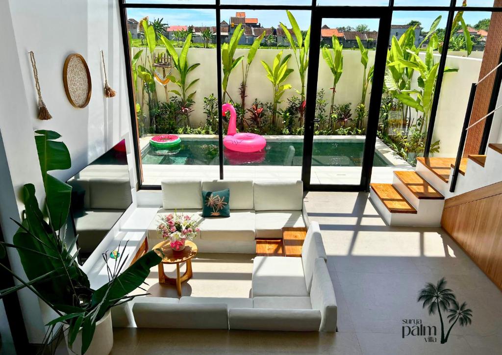a living room with a pink swan in a pool at Surya Palm Villa in Tumbak Bayuh