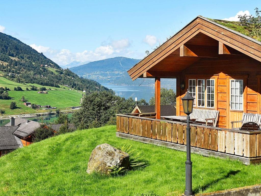 a cabin on a hill with a view of a lake at 5 person holiday home in olden in Olden
