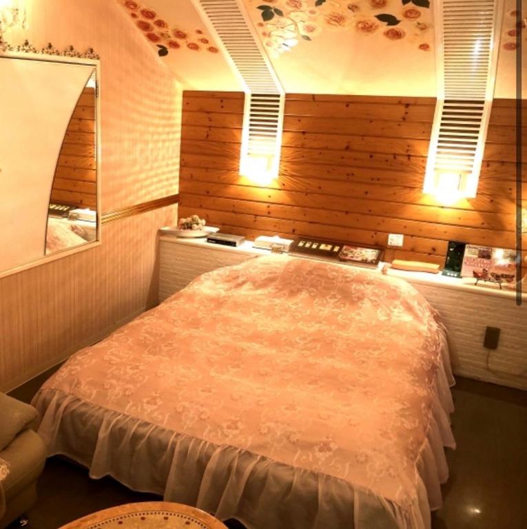 a bedroom with a large bed in a room at ホテルアドレ大人専用 in Hachinohe