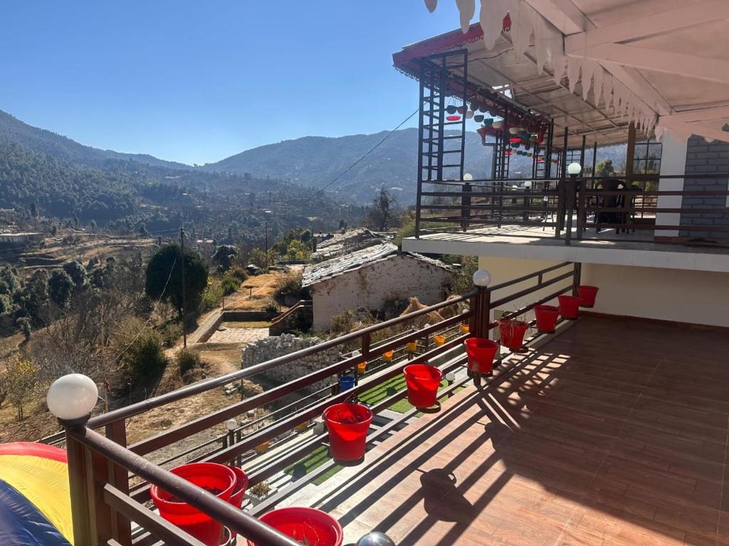 a balcony of a building with a view of the mountains at Mountview guest house in Mukteshwar
