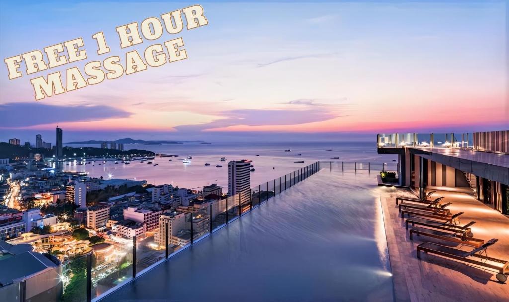 a view of the ocean from a hotel balcony at sunset at The Base Central Pattaya in Pattaya