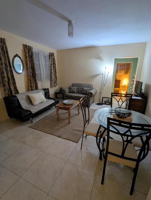 a living room with a couch and a table at Comsee Apartment Saint Mary in Highgate