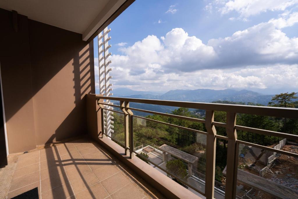 a balcony with a view of the mountains at 2BR Cloud 512 with Parking Slot in Baguio