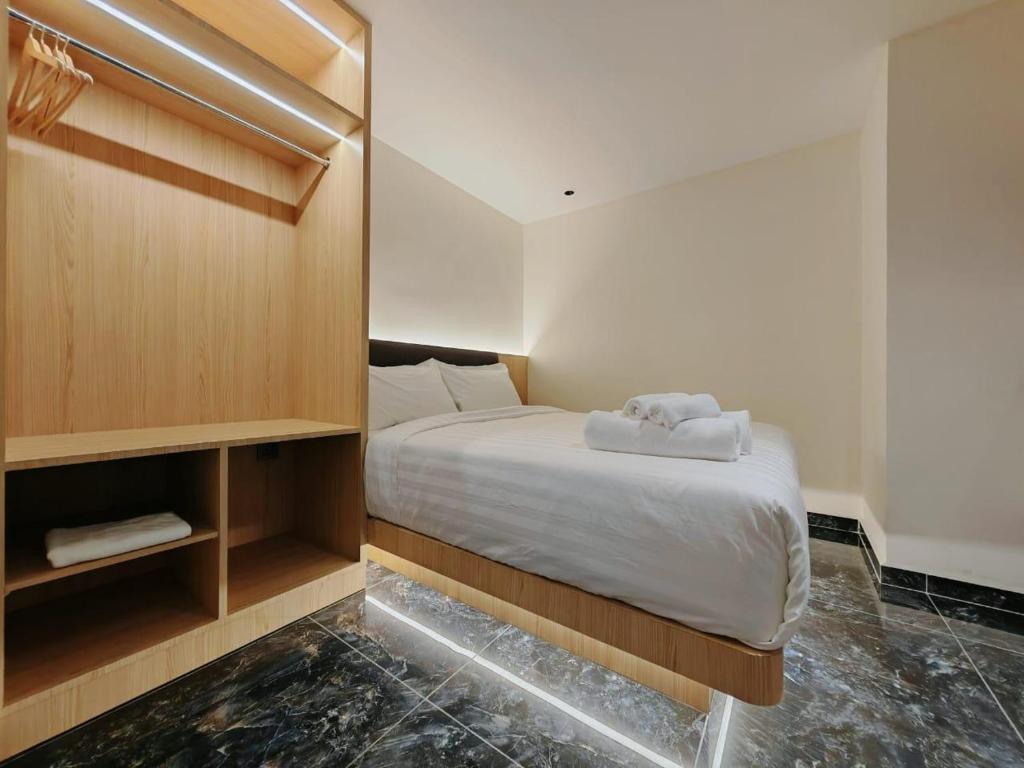a small bedroom with a bed and a mirror at Hotel Classic in Malacca