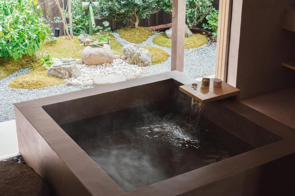 a koi pond in a house with a garden at MUDANI 達磨町 Darumacho in Kyoto