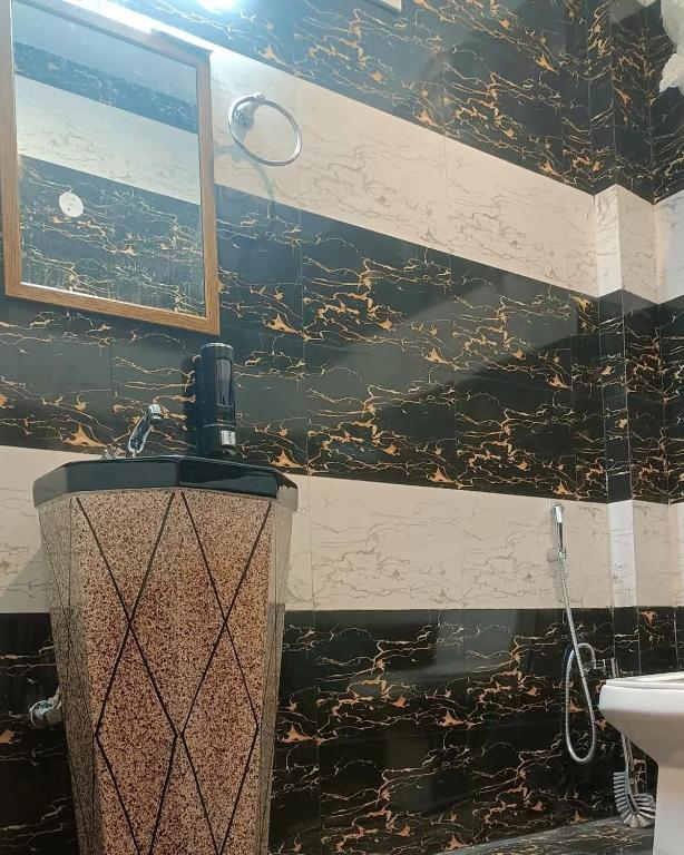 a bathroom with a shower and a toilet and a sink at Elite peak hotel in Kasauli