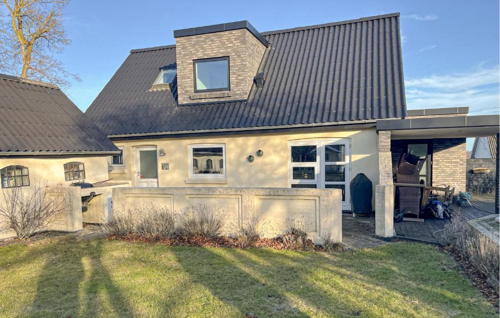 a house with a fence in front of it at Stunning Home In Sæby in Sæby
