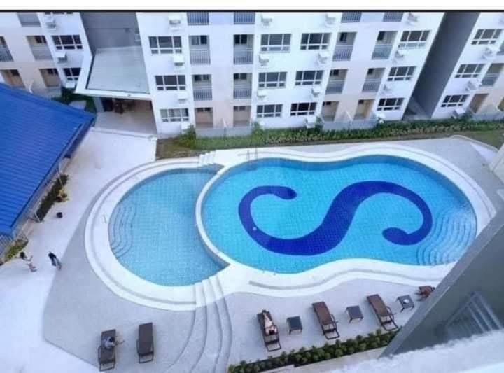 a swimming pool in front of a building at Seawind in Davao City