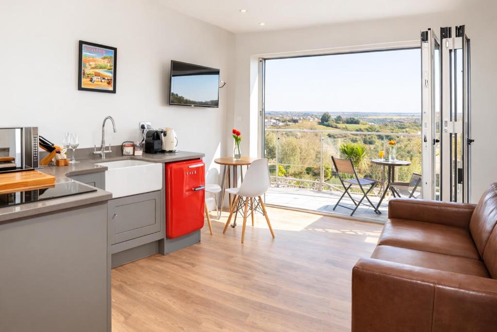 a kitchen and living room with a couch and a table at The View at 52, Whitby in Whitby