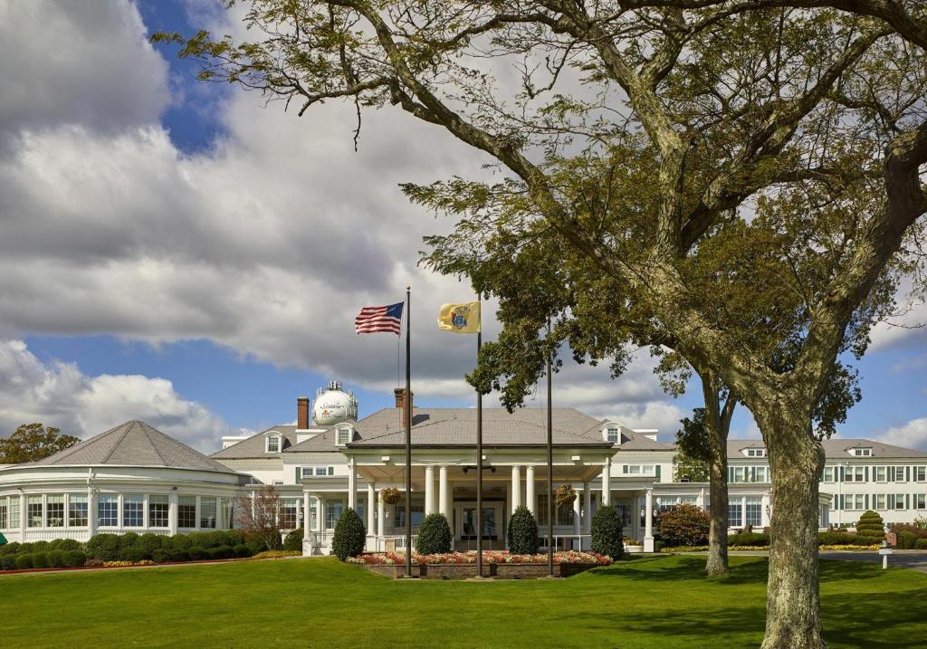 a large white house with an american flag in front at Seaview Hotel in Galloway