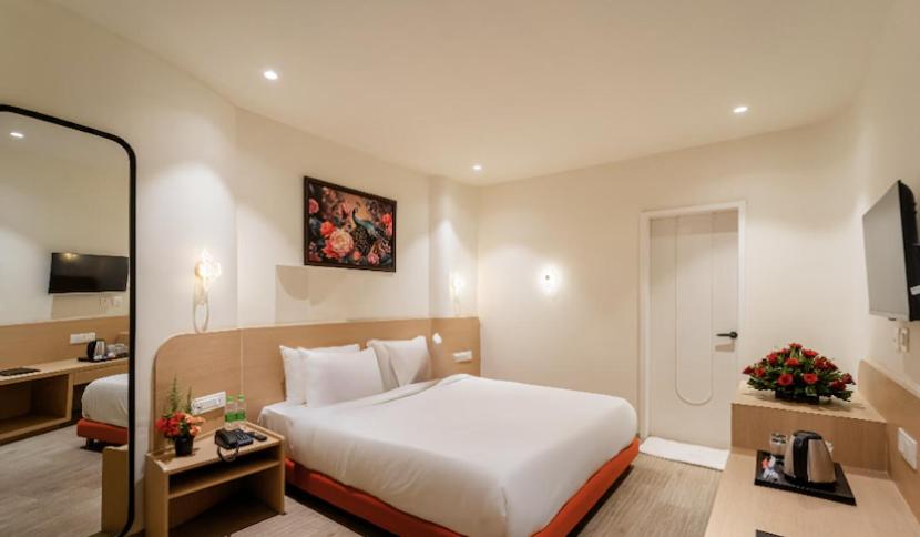 a hotel room with a bed and a bathroom at Hotel Benchmark Premier in Indore