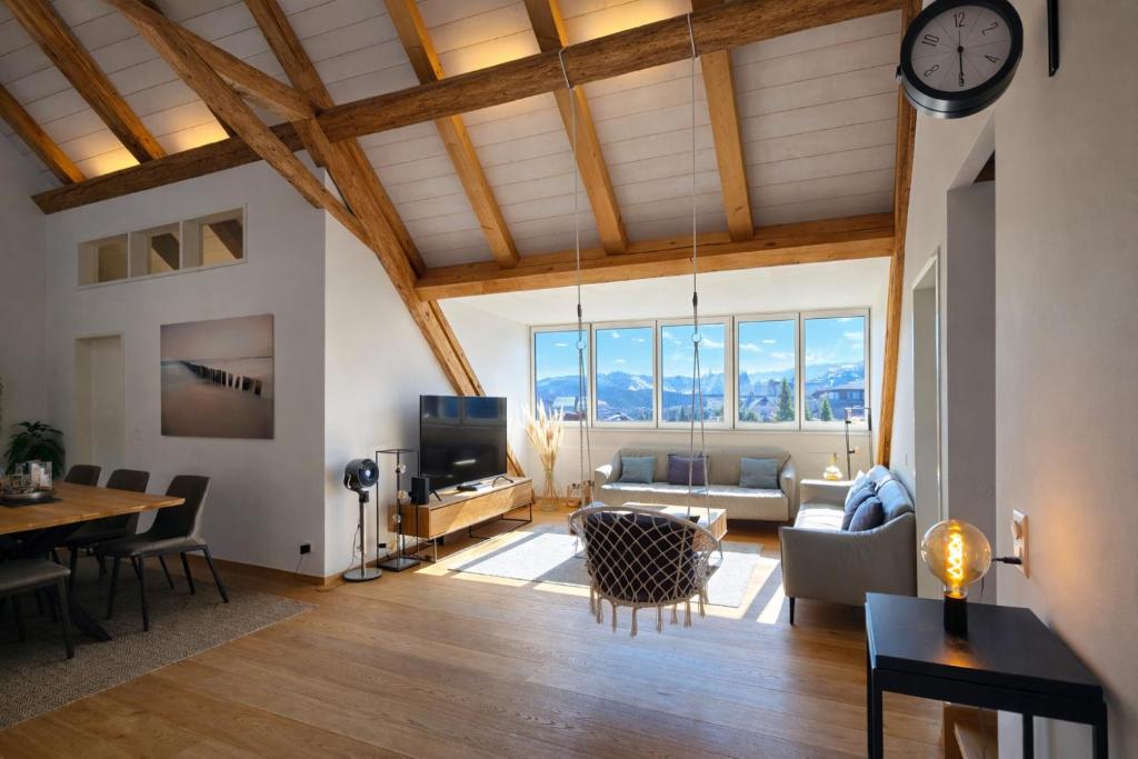 a living room with a clock on the ceiling at Niesen Loft in Spiez
