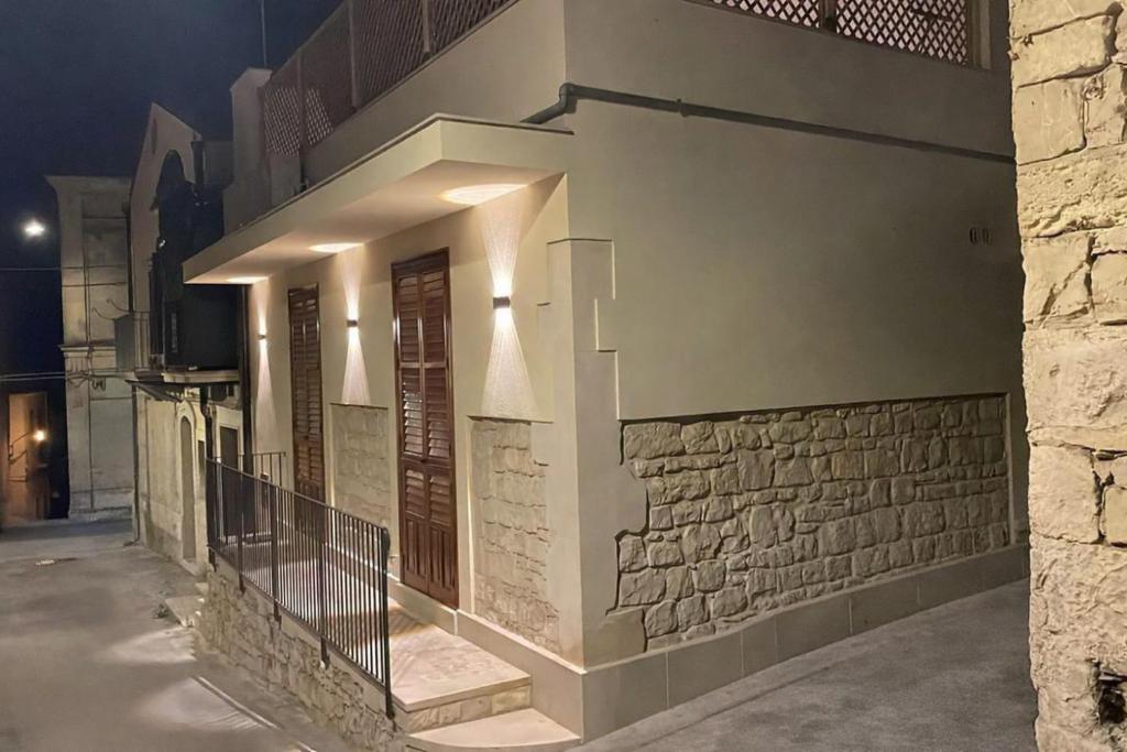 a building with lights on the side of it at ModicAlta in Modica