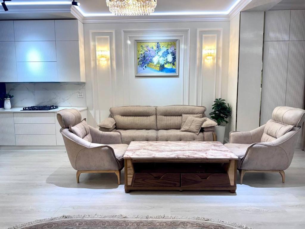 a living room with two couches and a coffee table at Boulevard in Samarkand