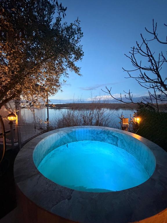 a swimming pool in the middle of a yard at night at 446 Tiny House Shirokë in Shirokë