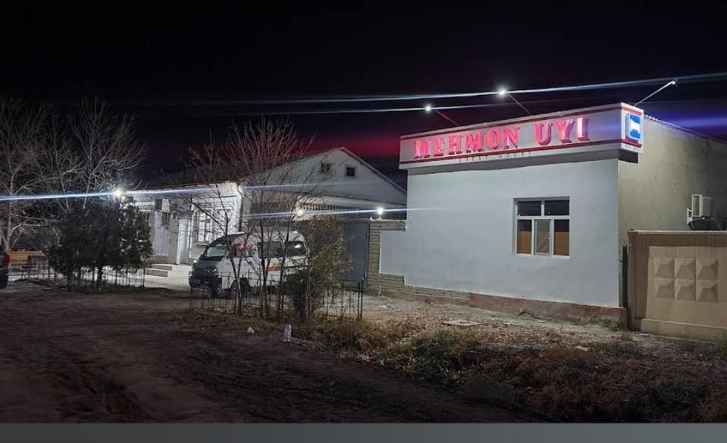 a gas station with a sign on the side of it at Umid Hostel in Qŭnghirot