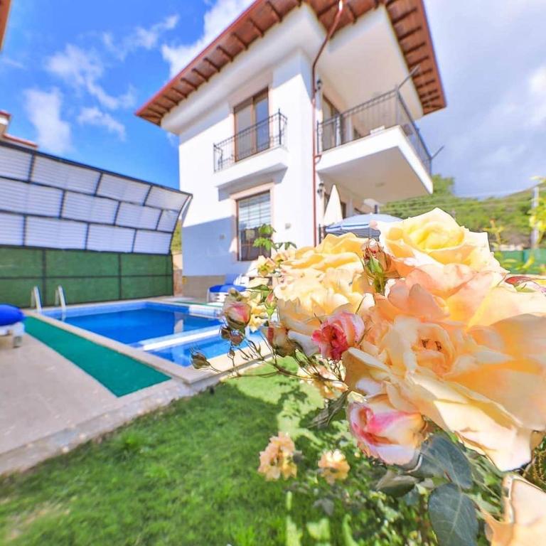 a bouquet of flowers in front of a house at Villa Mars in Kaş
