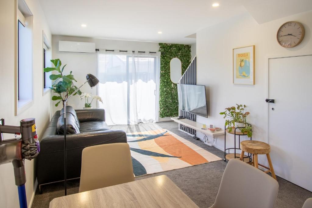 a living room with a couch and a tv at Charming 2-Bedroom Apartment - 2 BR, 1 Bath in Christchurch