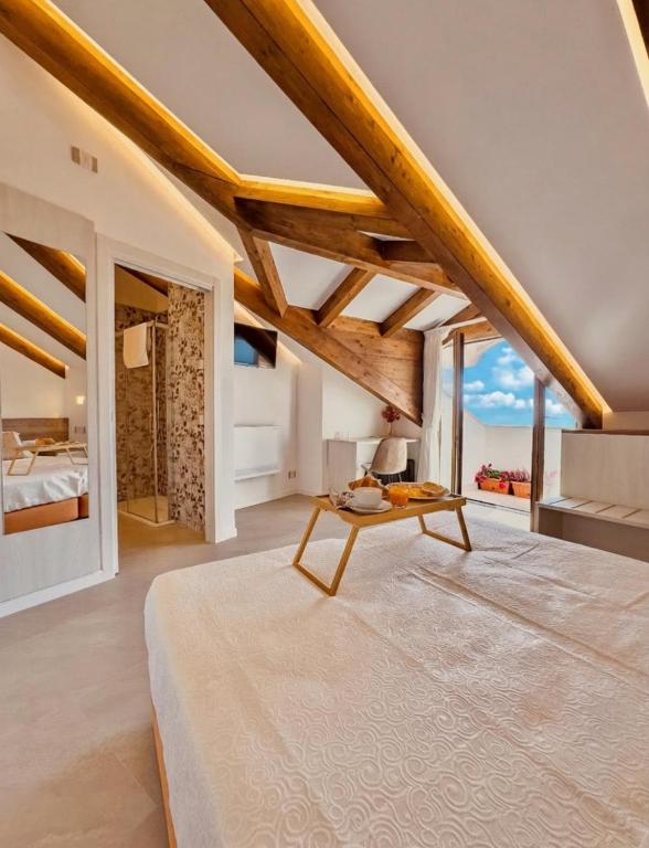 a bedroom with a table and a view of the ocean at Le Perseidi in Agerola