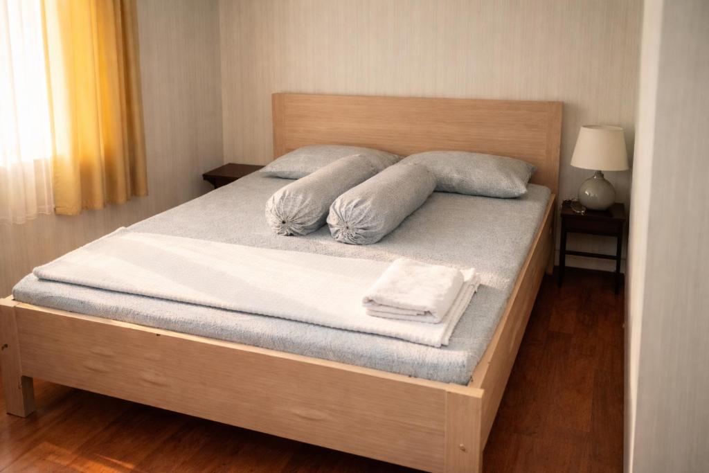 a bed with two pillows on top of it at Fideluna Beach Bungalow in Insyurifuri