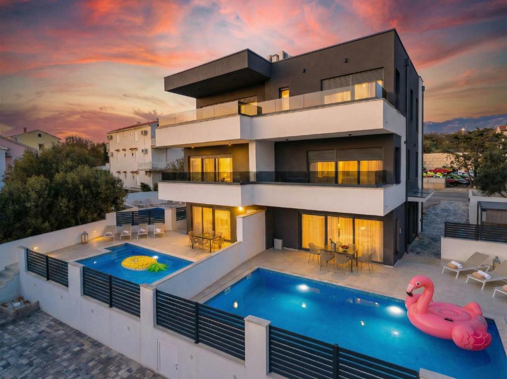 a house with a swimming pool in front of it at Black Diamond in Novalja