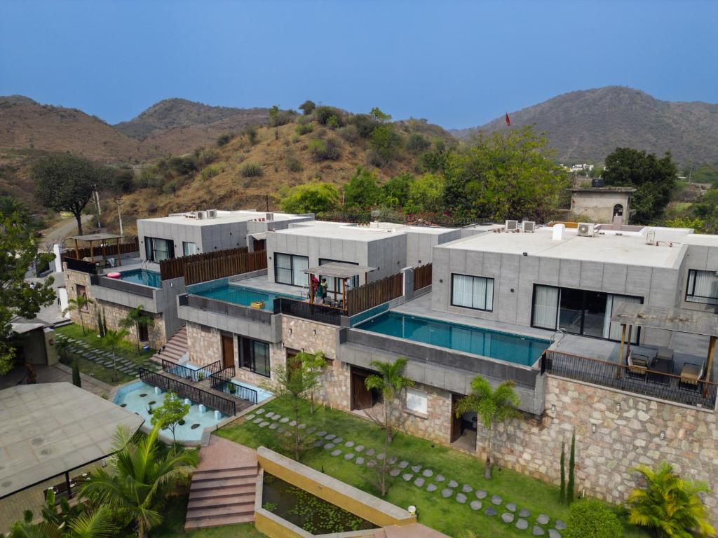 an aerial view of a house with a swimming pool at Kaizen Eirene Luxe Villas, Udaipur in Nāi