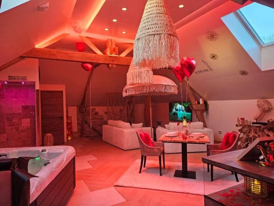 a living room with a couch and a chandelier at Romantic Love - So Lovely in Bailleval