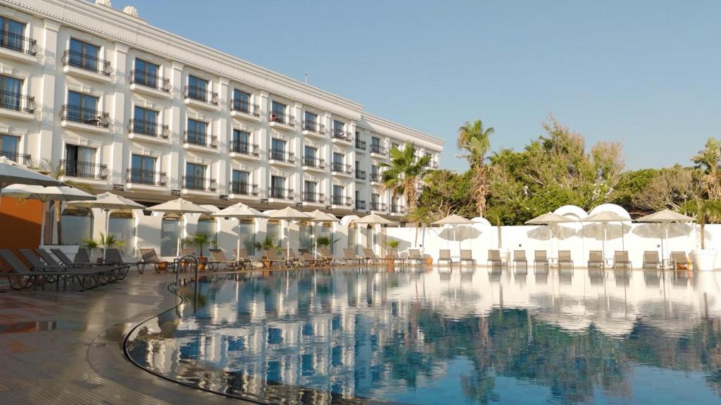 a hotel with a pool in front of a building at Rocks Hotel & Casino in Kyrenia