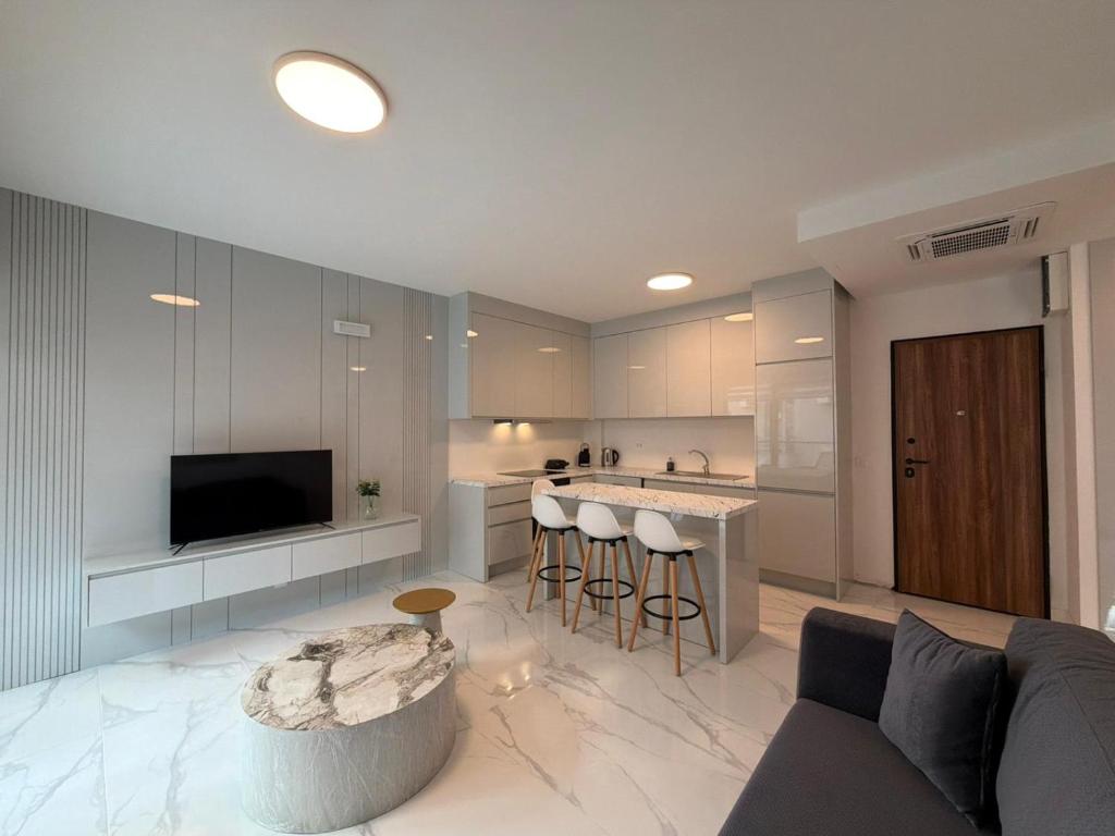 a living room with a couch and a kitchen at Miris Mora in Rafailovici
