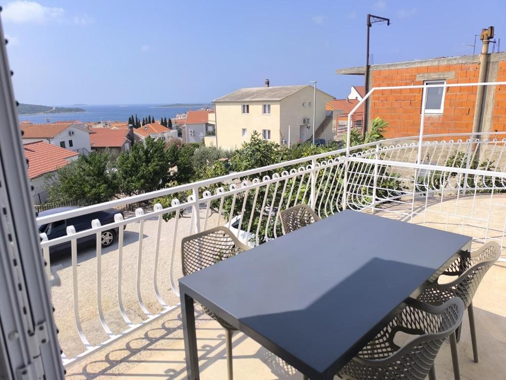 a blue table and chairs on a balcony at Apartments Ada in Primošten