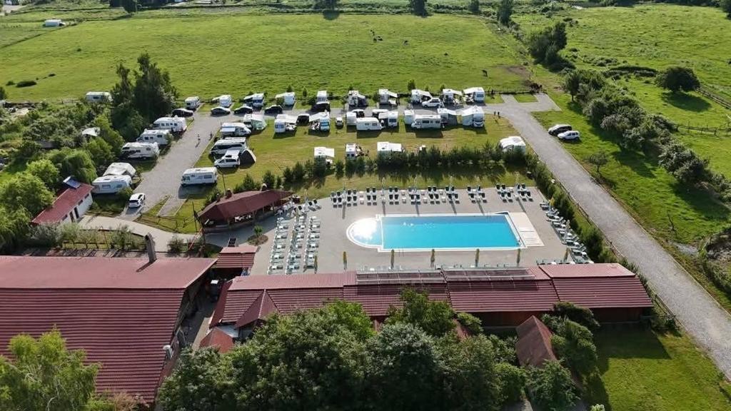 an aerial view of a parking lot with a pool at Complex Turistic Brândușa in Avrig