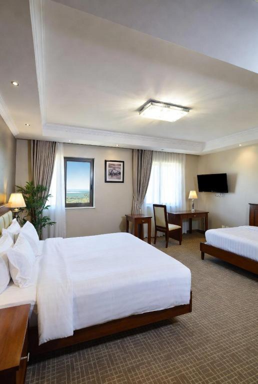 a hotel room with two beds and a television at Golden view hotel Tanzania in Dar es Salaam
