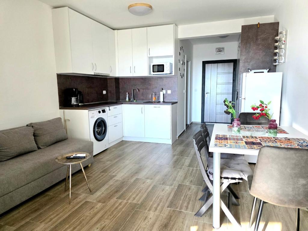 a kitchen and living room with a couch and a table at Sunny studio in Shartrez in Shkorpilovtsi
