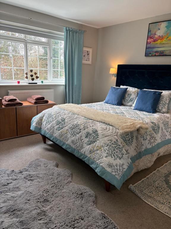 a bedroom with a large bed and a window at Were House Warminster in Warminster